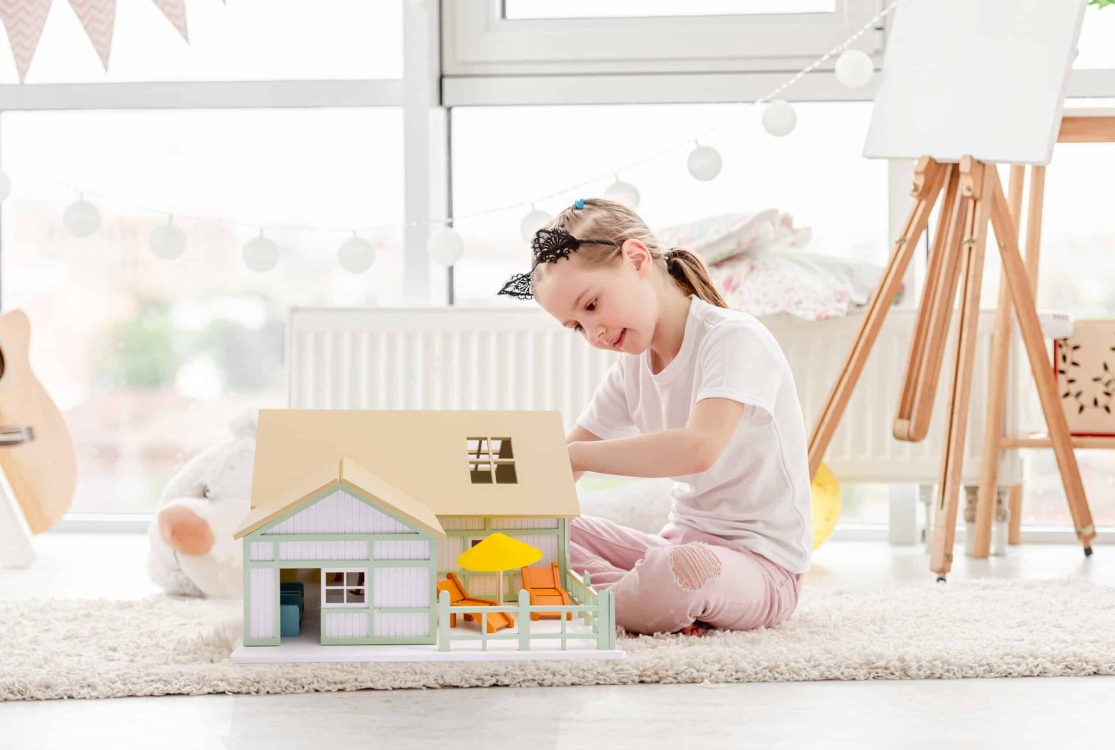 Pretty little girl playing with dollhouse House of Como - Image 3