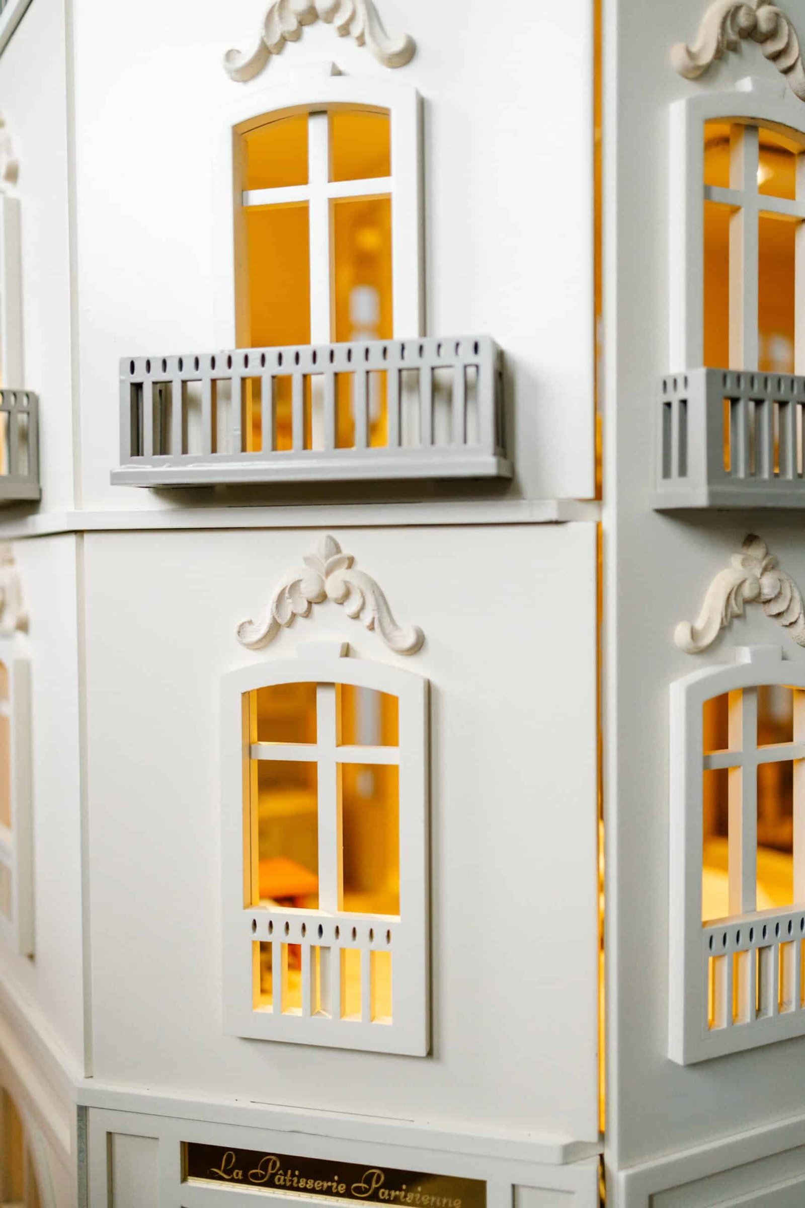 Paris Dollhouse – Four-Story Handcrafted Miniature Front view of the handcrafted four-story Paris Dollhouse featuring French architectural details and miniature storefront windows.