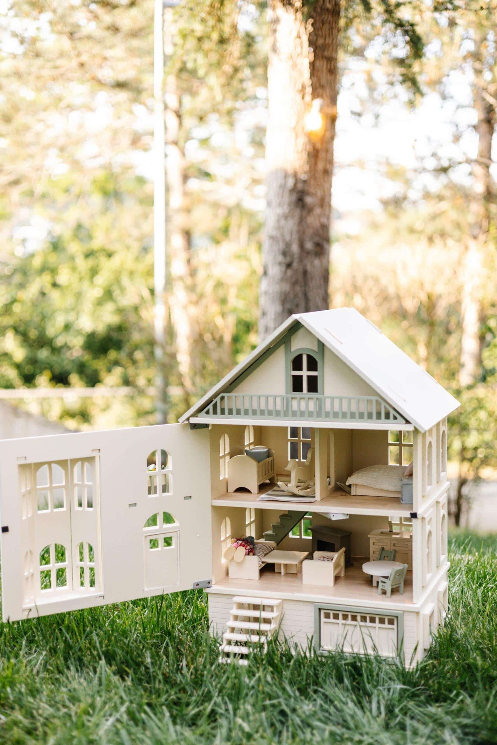 Victorian Wooden Dollhouse | Handcrafted by Little Forest Animals Victorian-style handcrafted white wooden dollhouse by Little Forest Animals, photographed outdoors on green grass in natural light.