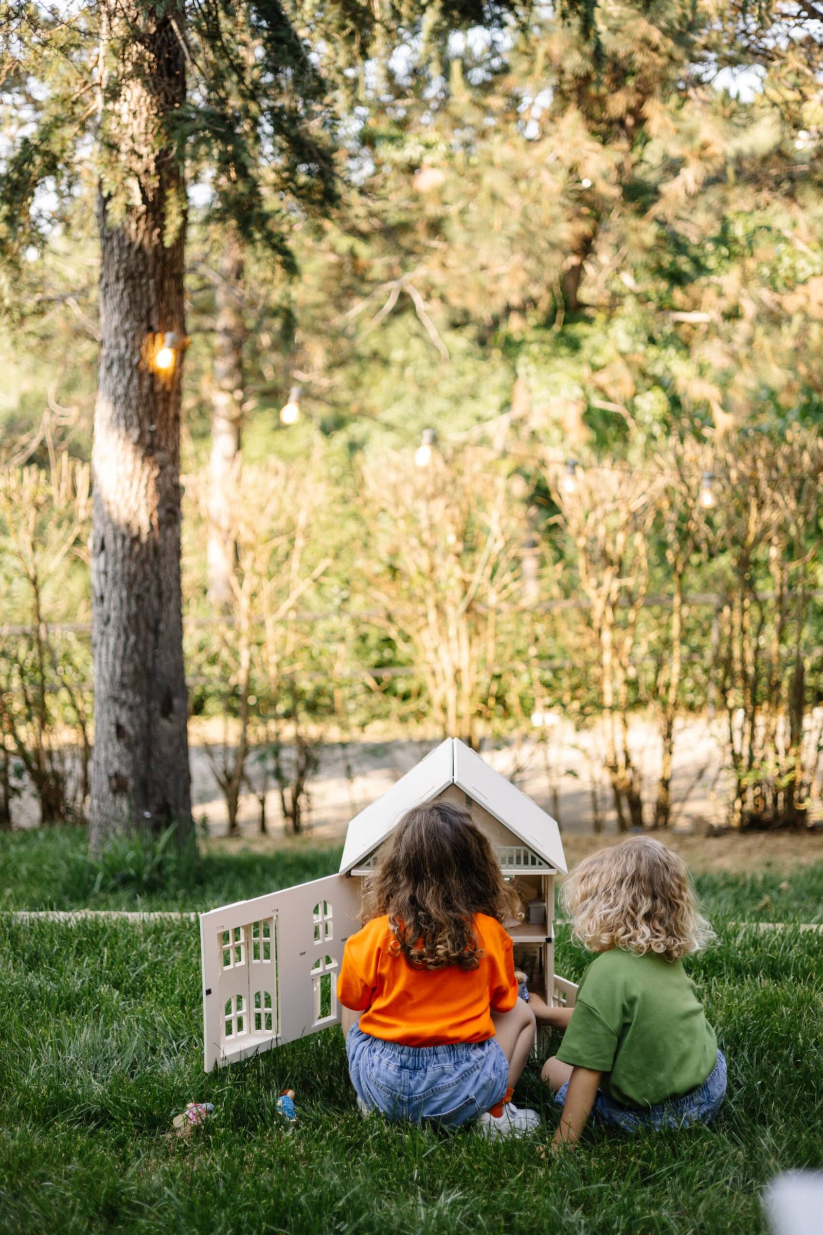 Victorian Wooden Dollhouse | Handcrafted by Little Forest Animals Victorian-style handcrafted white wooden dollhouse by Little Forest Animals, photographed outdoors on green grass in natural light.