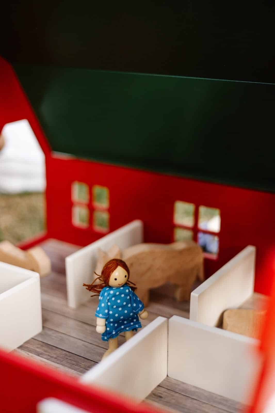 Handcrafted Barn-Style Wooden Dollhouse | Little Forest Animals Handcrafted red wooden barn-style dollhouse with green roof, designed by Little Forest Animals for sustainable and imaginative play.