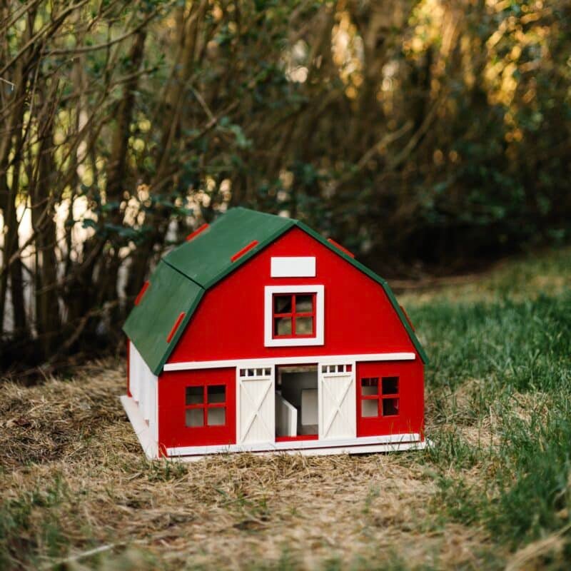 Little Forest Animals 14 Handcrafted red wooden barn-style dollhouse with green roof, designed by Little Forest Animals for sustainable and imaginative play.