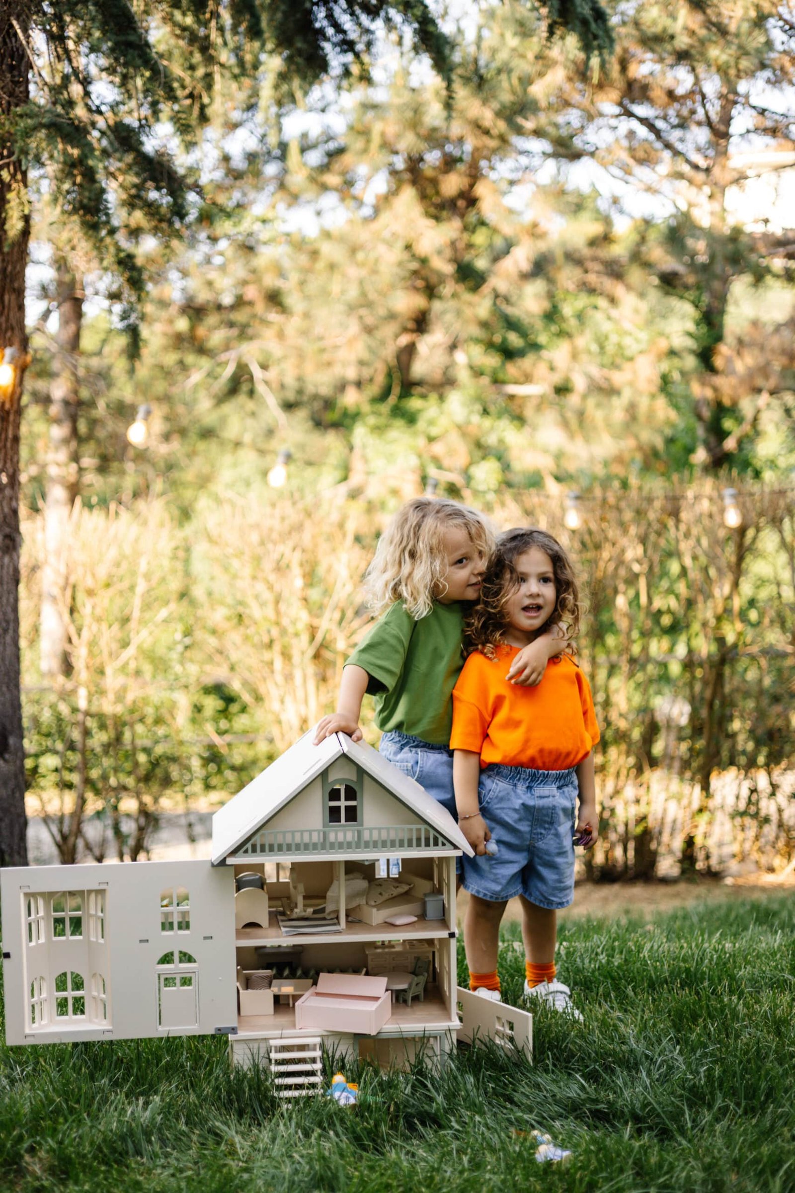 Victorian Wooden Dollhouse | Handcrafted by Little Forest Animals Victorian-style handcrafted white wooden dollhouse by Little Forest Animals, photographed outdoors on green grass in natural light.