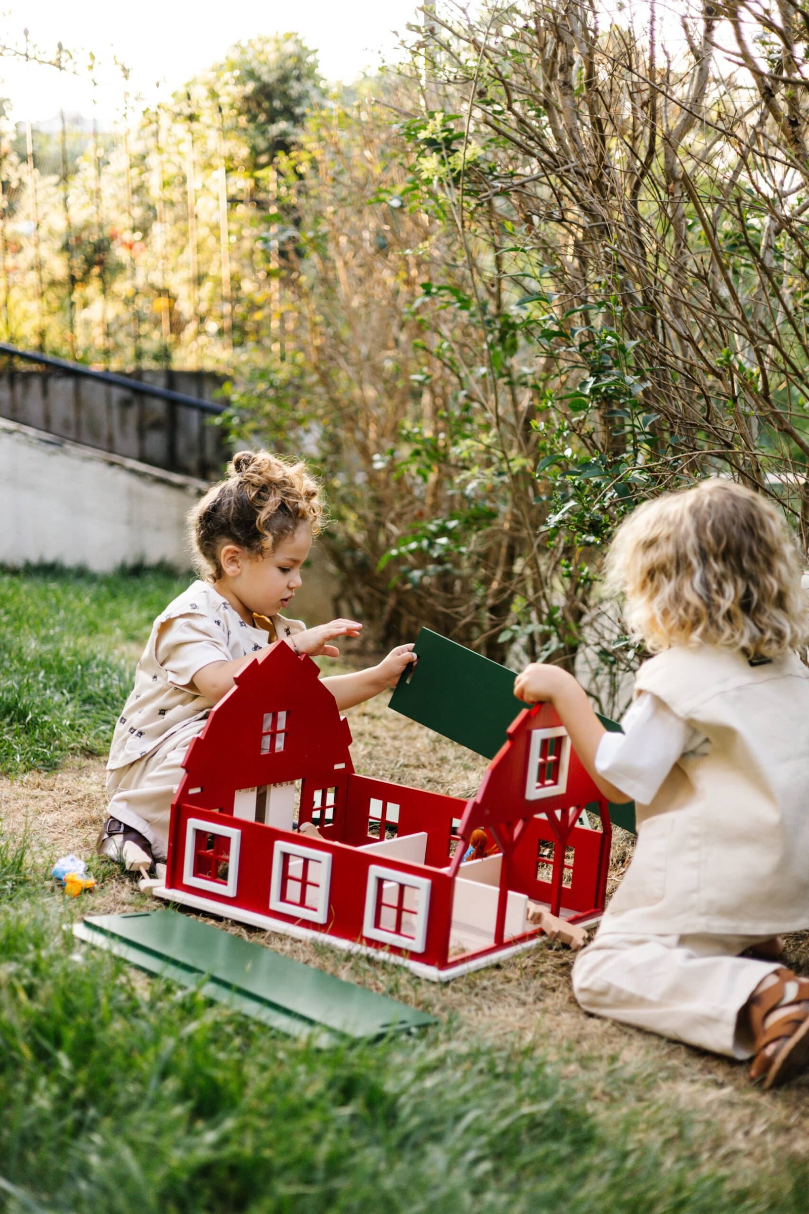 IMG_5771 2 Handcrafted red wooden barn-style dollhouse with green roof, designed by Little Forest Animals for sustainable and imaginative play.