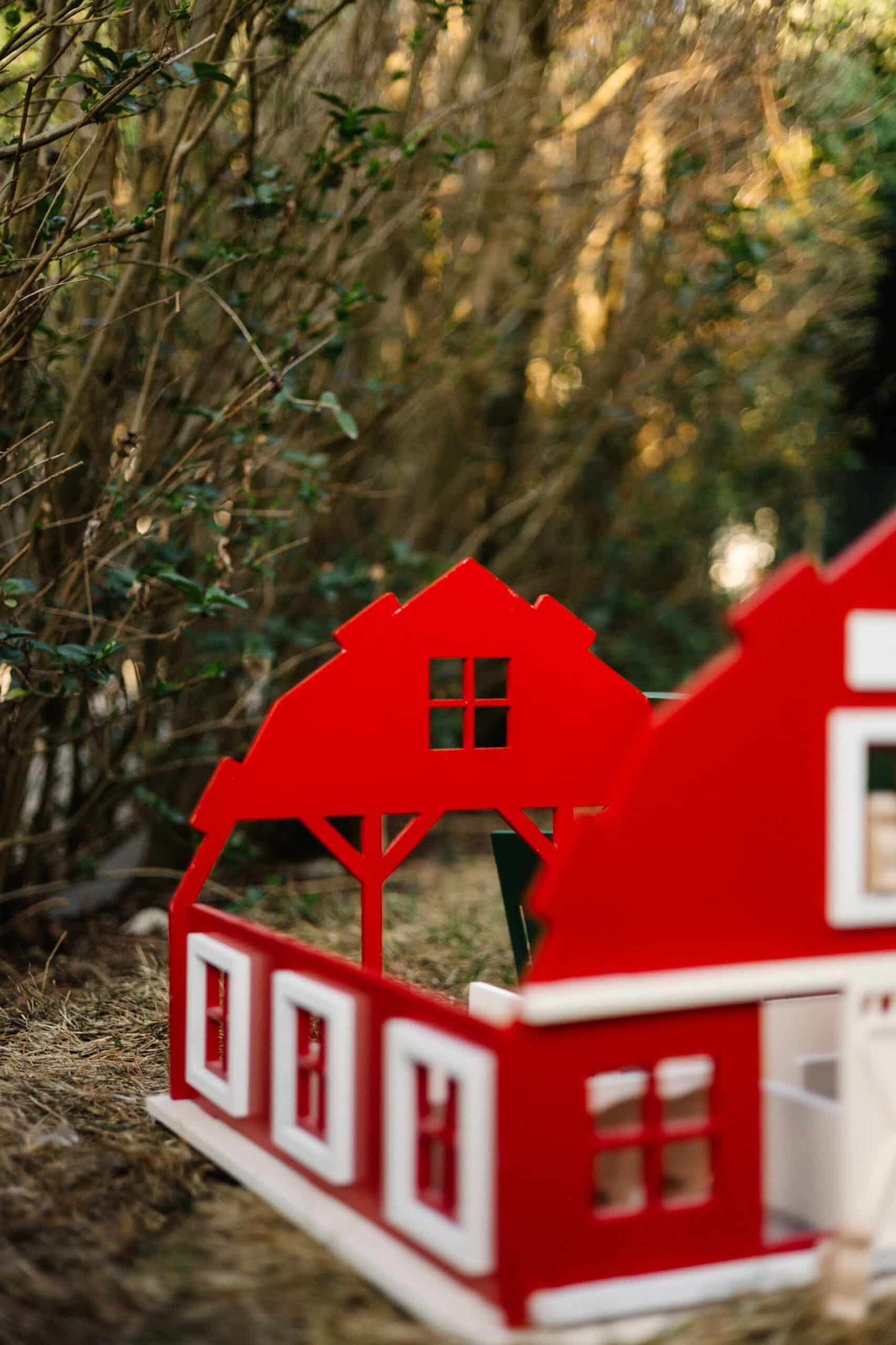Handcrafted Barn-Style Wooden Dollhouse | Little Forest Animals Handcrafted red wooden barn-style dollhouse with green roof, designed by Little Forest Animals for sustainable and imaginative play.