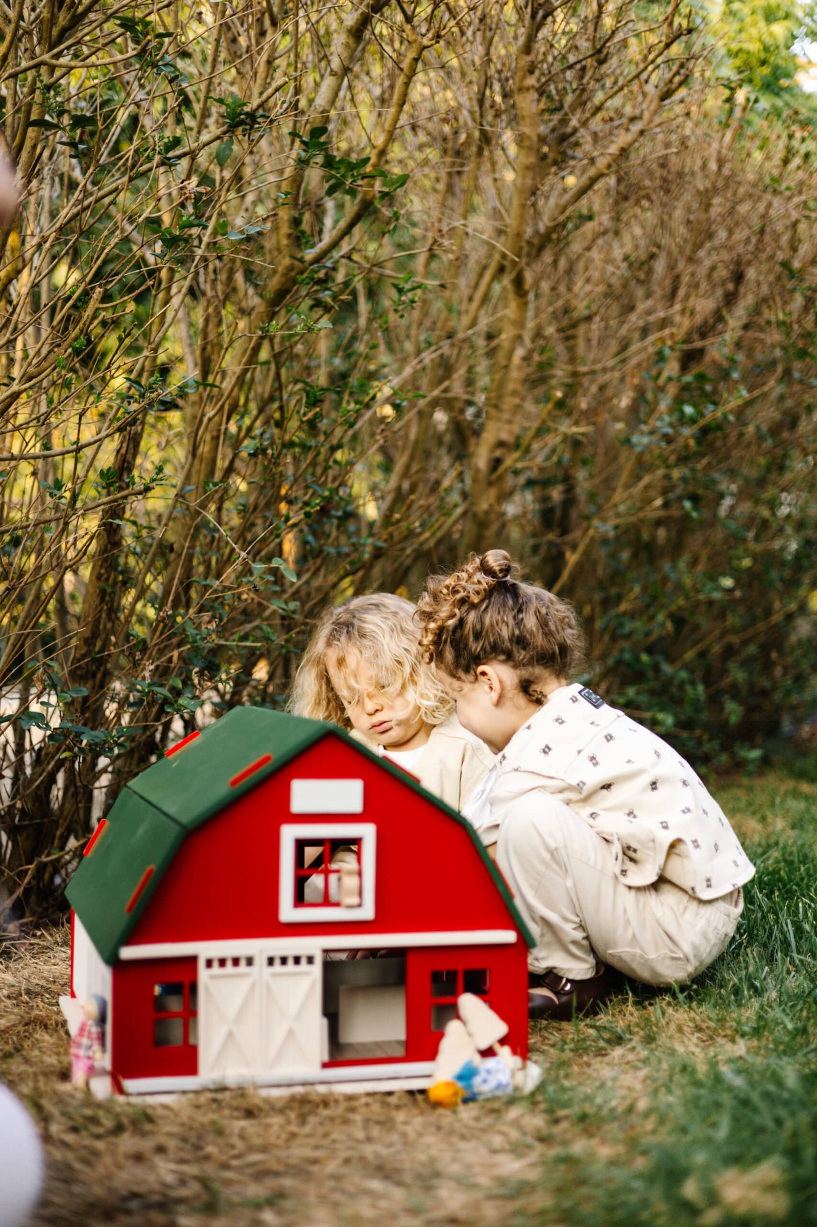 Handcrafted Barn-Style Wooden Dollhouse | Little Forest Animals Handcrafted red wooden barn-style dollhouse with green roof, designed by Little Forest Animals for sustainable and imaginative play.