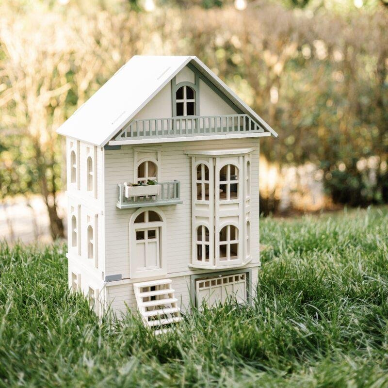 Little Forest Animals 10 Victorian-style handcrafted white wooden dollhouse by Little Forest Animals, photographed outdoors on green grass in natural light.