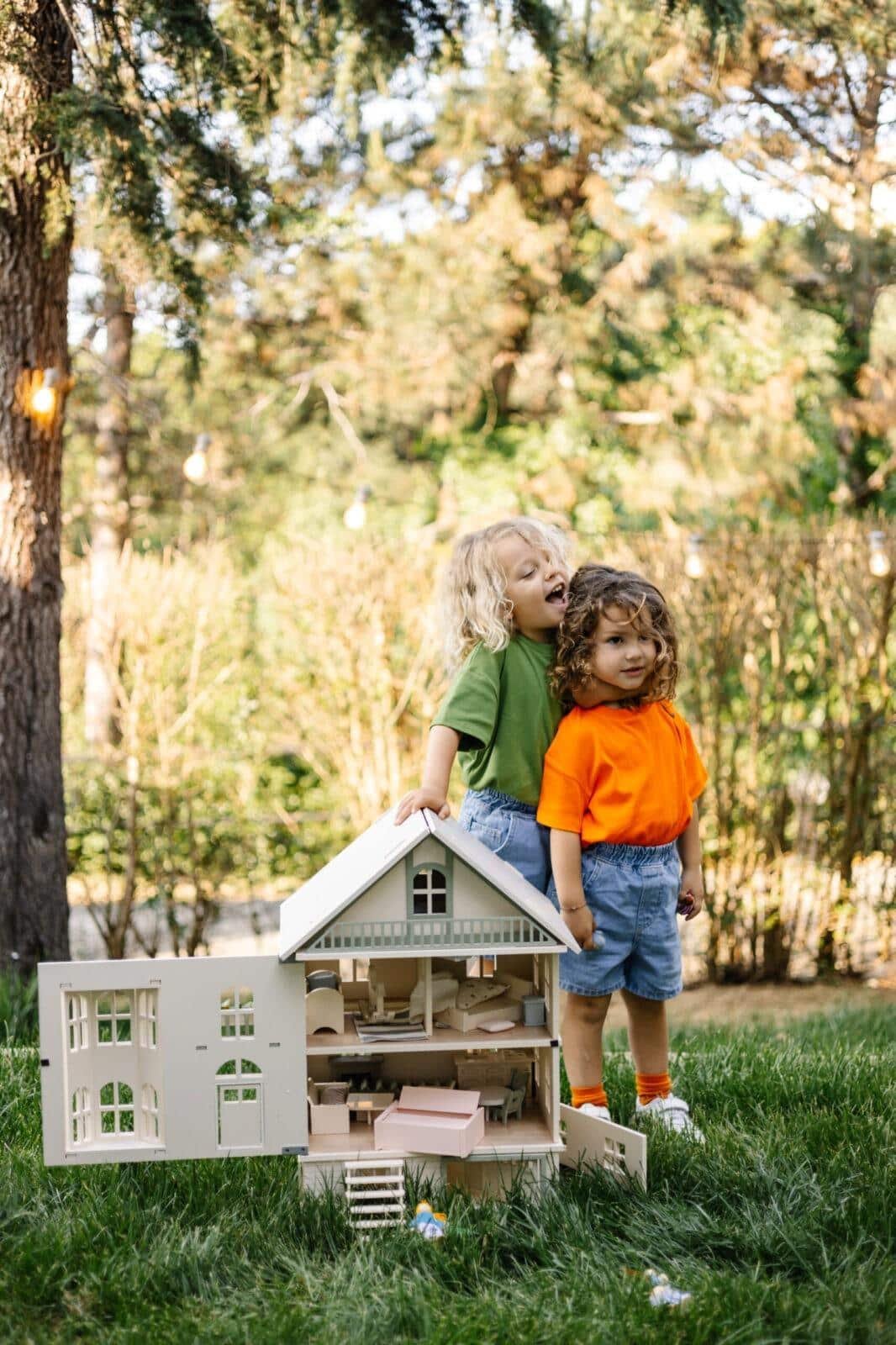 Victorian Wooden Dollhouse | Handcrafted by Little Forest Animals Victorian-style handcrafted white wooden dollhouse by Little Forest Animals, photographed outdoors on green grass in natural light.